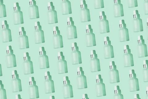 Dropper bottle pattern on the mint background Stock Photos