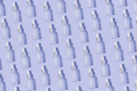 Dropper bottle pattern on the purple background Stock Photos