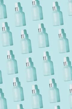 Dropper bottle pattern vertical photo on the blue background Stock Photos