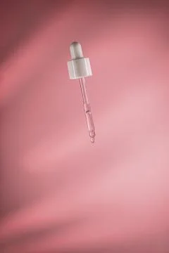 Dropper dispensing a single drop of clear cosmetic serum, highlighting skincare Stock Photos