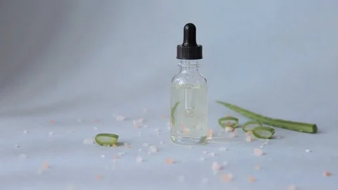 Dropper glass bottle with pipette. Mock up Essential liquid with aloe vera Stock Footage 112551853