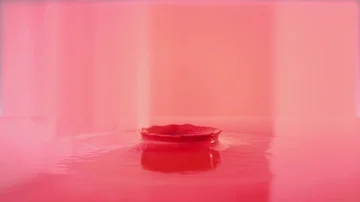 Dropping ball in red paint making beautiful crown splash Stock Footage 85930716