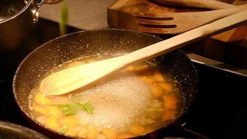 Dropping beans into a soup mix Stock Footage 93691195