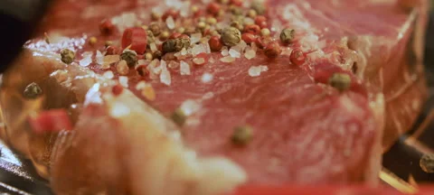 Dropping beef steak on iron grill Video stock 311834646