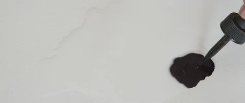 Dropping black ink on canvas, with dropper Stock Footage 101688921