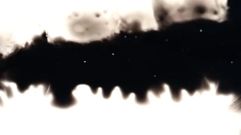 Dropping black ink over a white screen in a line Stock Footage 147703678