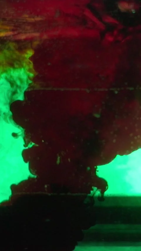 Dropping blood red splatter paint in a water paint Stock Footage 327532518