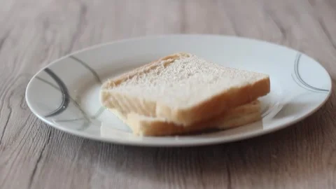 Dropping bread into a plate. Toast bread on a plate Stock Footage 242537694