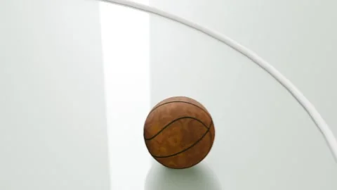 Dropping brown leather basketball bouncing on glossy pale court panel, passing Stock Footage 333629279