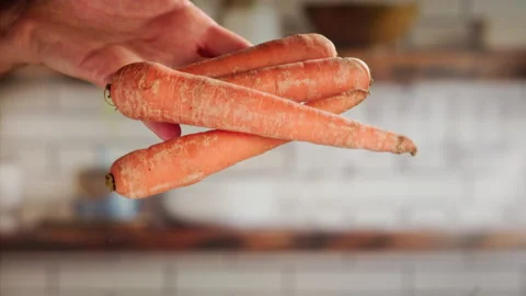 Dropping carrots in slow motion Stock Footage 156845863