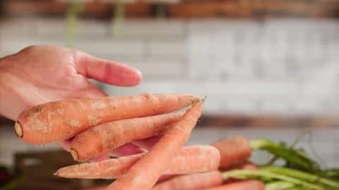 Dropping carrots in slow motion Stock Footage 158307210