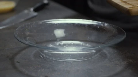 Dropping chopped cherry tomatoes on plate Stock Footage 125989418