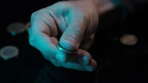 Dropping Coins in Low Light – Financial Risk and Economy Concept Stock Footage 306311871