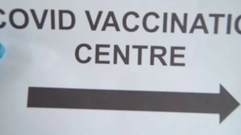 Dropping COVID Vaccination Centre Sign In White Bin Stock Footage 157174064
