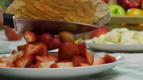 Dropping diced strawberries onto plate - closeup slow motion shot 스톡 동영상 341231294