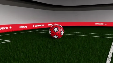 Dropping down, red soccer ball rotating, landing, settling on turf near goal Stock Footage 333286176