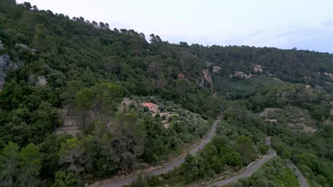 Dropping down on switchback road by French villa in mountain landscape 스톡 동영상 245633525