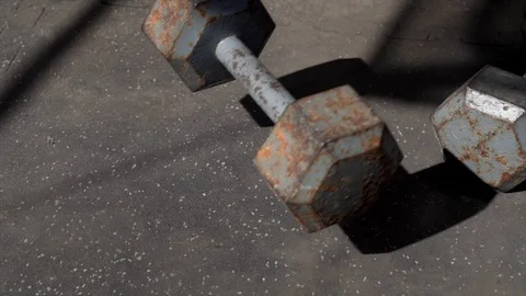 Dropping dumb bell weights outside gym dust flies slow motion Stock Footage 125346338
