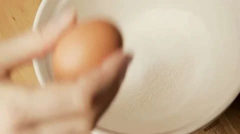 Dropping egg into bowl Stock Footage 10921517