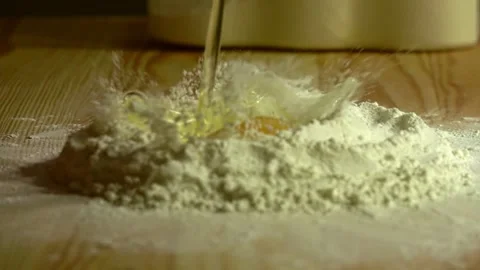 Dropping egg on flour, means for making cookies Stock Footage 231897132