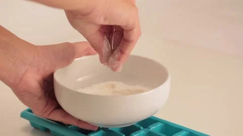 	dropping flour in a plastic ice cube tray Video stock 133811652