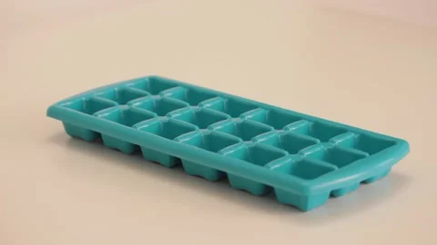 Dropping flour in a plastic ice cube tray Video stock 133811730