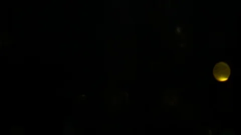 Dropping gold powder into the water Stock Footage 102292702