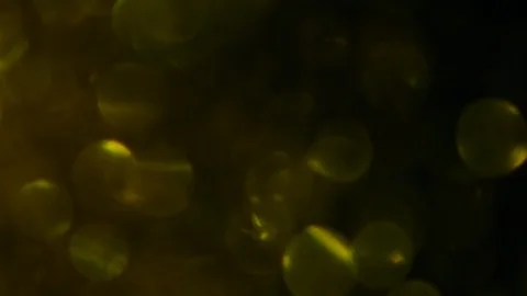 Dropping gold powder into the water Stock Footage 102405810