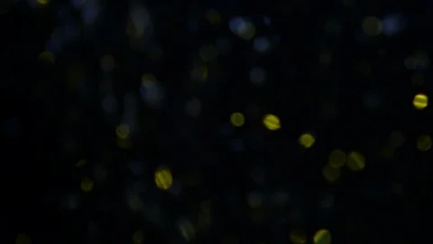 Dropping gold powder into the water Stock Footage 102423899