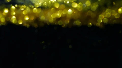Dropping gold powder into the water Stock Footage 102434428