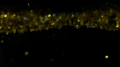 Dropping gold powder into the water Stock Footage 102471307