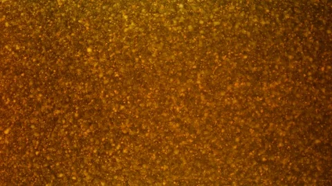Dropping gold powder into the water Stock Footage 114201503