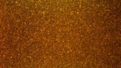 Dropping gold powder into the water Stock Footage 114201537