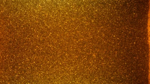Dropping gold powder into the water Stock Footage 114201539