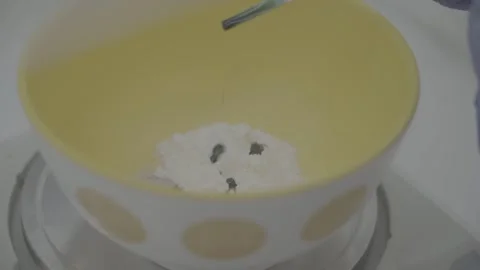 Dropping green liquid into white powder for laboratory testing. 動画素材 330239860