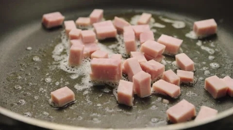 Dropping ham into the pan Stock Footage 61796405