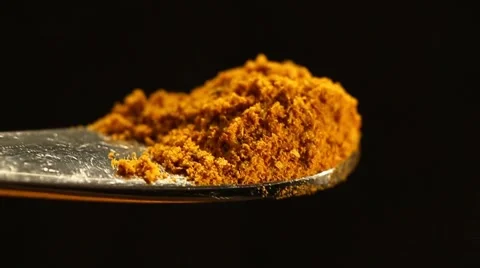 Dropping A handful of Turmeric powder Stock Footage 49500987