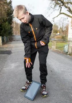 Dropping his tablet on a stroll Stock Photos