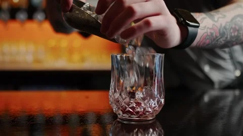 Dropping ice in to an alcohol drink Stock Footage 301412059