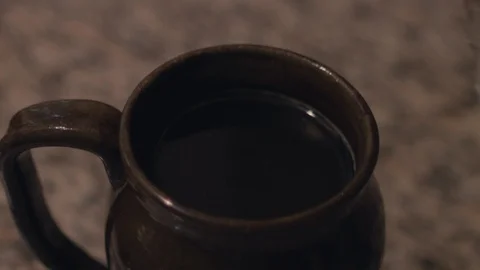 Dropping ice cubes into black coffee in slow motion. Stock Footage 93612360