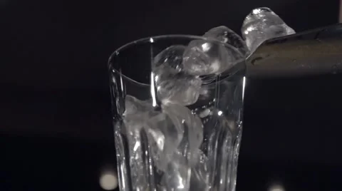 Dropping ice into a wineglass in slow motion Stock Footage 67857296