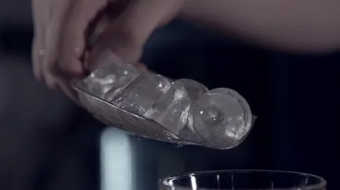 Dropping ice into a wineglass in slow motion Stock Footage 67866978