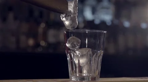 Dropping ice into a wineglass in slow motion Stock Footage 67867348