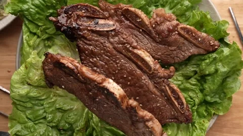 Dropping korean style bbq short rib on lettuce slow motion 240p Stock Footage 157991188