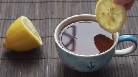Dropping lemon slice into the tea. Stock Footage 126836653