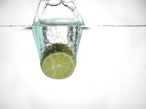 Dropping lime in water Stock Photos