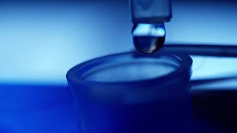 Dropping liquid solution into a test tube macro Stock Footage 218619786