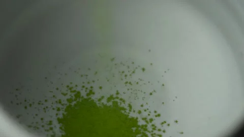 Dropping match powder in tea cup	 Stock Footage 158321111