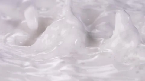 Dropping milk from above slow motion camera Video stock 248406458