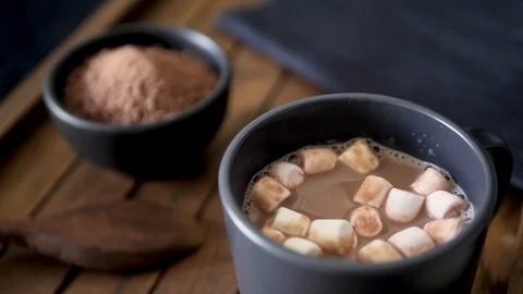 Dropping mini marshmallows into a mug of hot chocolate. Stock Footage 112930575